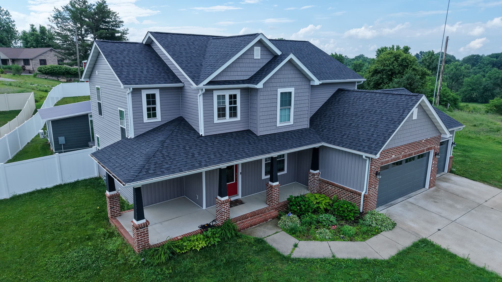 A two-story St. Louis home finished by H&F, with new roofing, crisp lap siding, and replacement windows